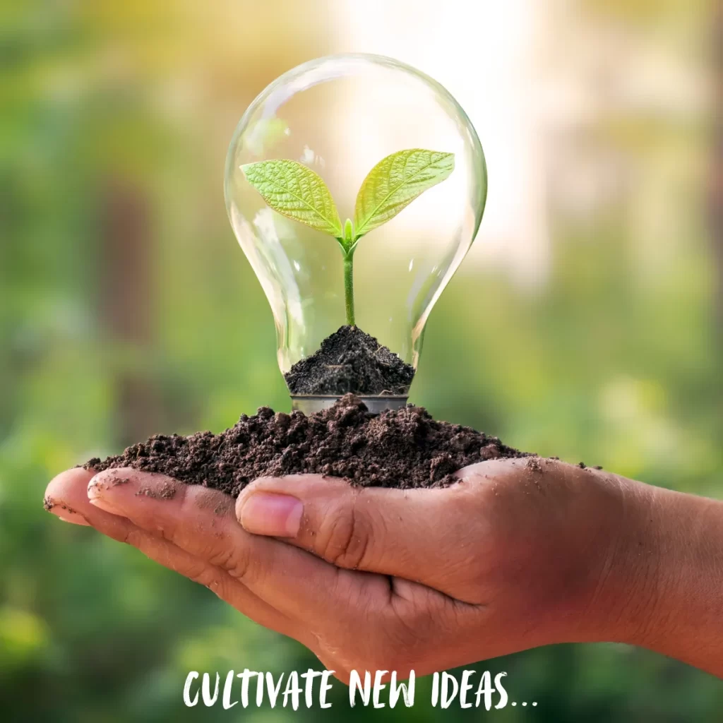 Cultivate new ideas... hand holding a lightbulb with a seedling inside